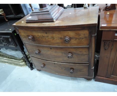 A 19th century mahogany bow front chest of three long drawers on bun feet