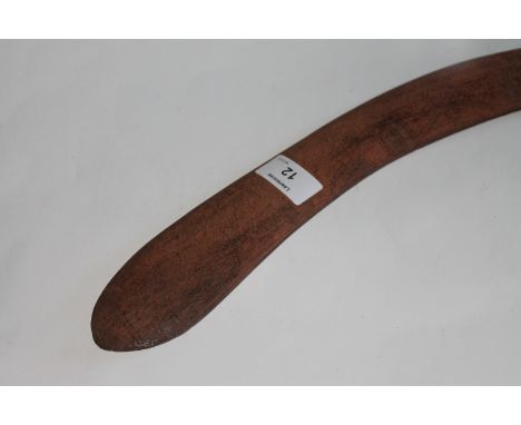 A BOOMERANG. A Boomerang with geometric carvings, having the elongated throwing arm. 30.1/2" in length with the longer arm me