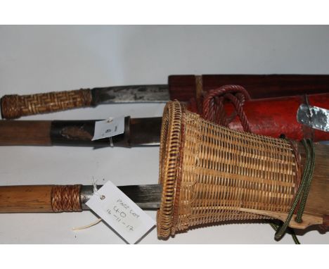 DYAK KNIVES etc A Burmese hatchet bladed knife in red painted wooden scabbard, with 7.1/2" blade. Two modern Kalaw knives and