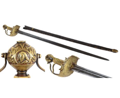 A 17thC MORTUARY SWORD. A 17thC Mortuary Sword with cast brass hilt and shell decoration, with the head of Charles 1? on the 