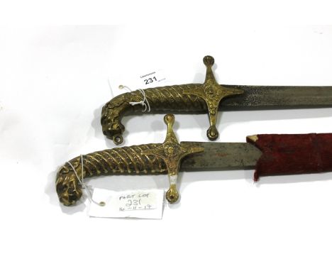 A 19thC TIGERS POMMEL TULWAR SWORD. A cast brass hilted Tulwar sword with Tigers head pommel and decorative grip and crossgua