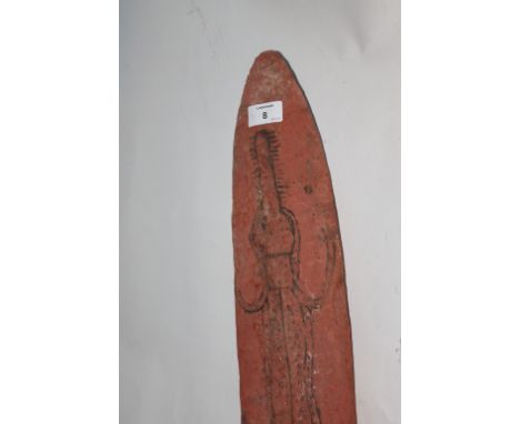 AN ABORIGINAL SHIELD. A carved wooden Aboriginal shield, measuring some 28.1/2" long by 5.3/4" wide. The front is decorated w