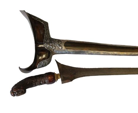 A JAVANESE KRIS. A silver mounted Javanese Kris with intricately carved wooden hilt, with 11" watered steel blade. The wooden