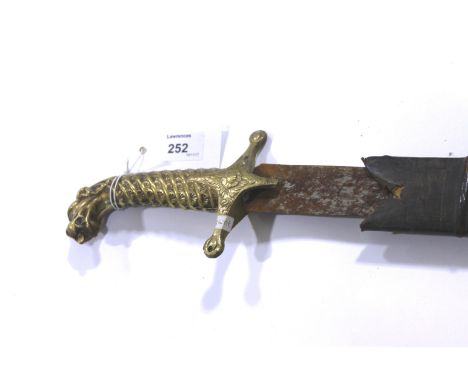 AN INDIAN SWORD & SCABBARD. A Tulwar with Tiger Head pommel and cast grip, 31" curved (rusty) single-edged blade complete wit