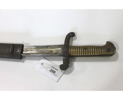 A FRENCH 1842 PATTERN BAYONET. A French model 1842/59 sabre bayonet complete with steel scabbard and various markings.