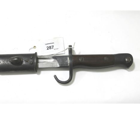 A 1907 BAYONET & SCABBARD (EFD). A 1907 Enfield made bayonet with swept forward quillion and brown leather and steel mounted 