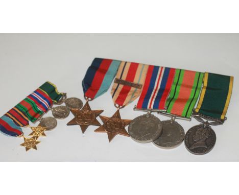 A TEM GROUP OF FIVE & MATCHING MINIATURES. A 1939/45 and Africa Stars (*th Army Bar), Defence & War Medals, also a GV1 Territ