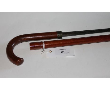 A SWORDSTICK. A cane mounted swordstick with triangular hollow-ground rapier blade, of 21,1/4" length.
