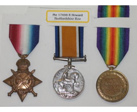 A BEDFORDSHIRE REGT TRIO. A 1914/15 Star, British War & VIctory Medals named to 17498 Pte (A.Cpl) R Howard, Bedf R. Robert Ho