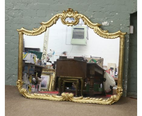 A large gilt framed hall mirror with arch top pediment.