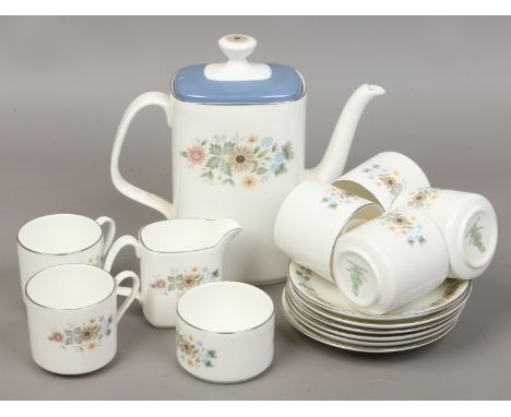 A Royal Doulton bone china service decorated in the pastoral design including a teapot, sugar bowl, milk jug and six cups and