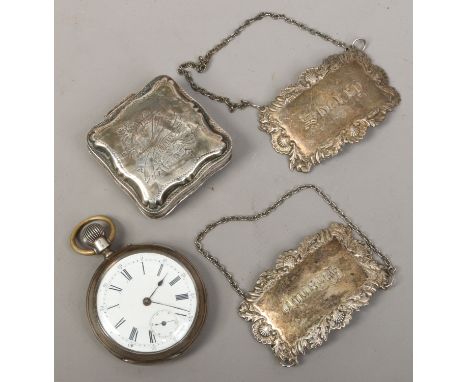 A Swiss silver pocket watch with white enamel dial Roman numeral markers and subsidiary seconds, along with two silver plate 