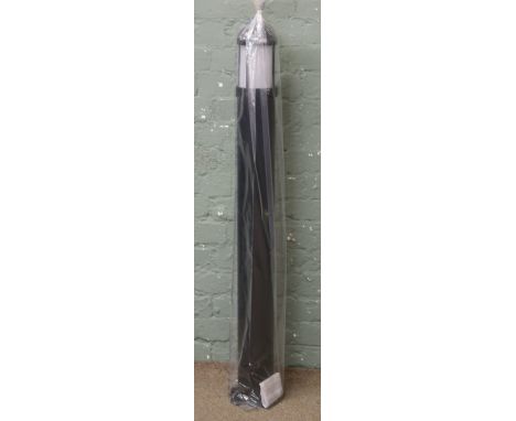 A black driveway bollard night light by J.C.C lighting products.
