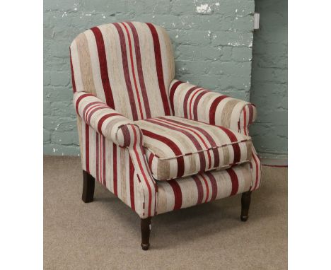 A tub armchair upholstered in a burgundy and cream stripe and raised on slender supports.