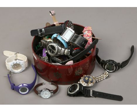 A tin of ladies and gents wristwatches including Casio, Sekonda, Lorus, DKNY etc.