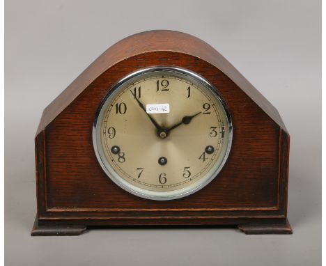 An oak cased Westminster chime mantel clock with key and pendulum by Garrard Clock Ltd England.