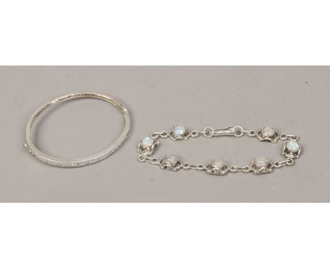 A silver and moonstone bracelet along with a silver bangle set with white paste stones