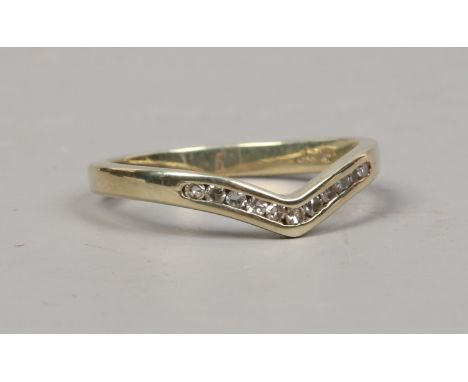 A 9ct gold channel set diamond wishbone ring size K