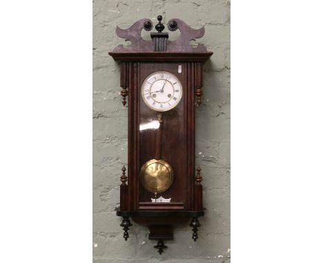 A walnut Vienna wall clock housing an eight day Junghans movement striking on a gong c1880s.