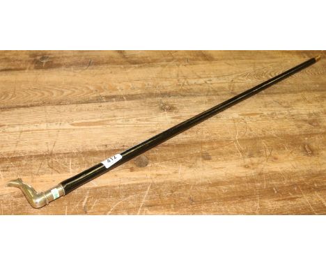 A brass handle ebonized walking stick formed as a booted leg.