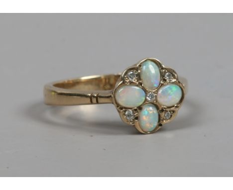 A 9ct gold opal and diamond floriform ring. Size N.