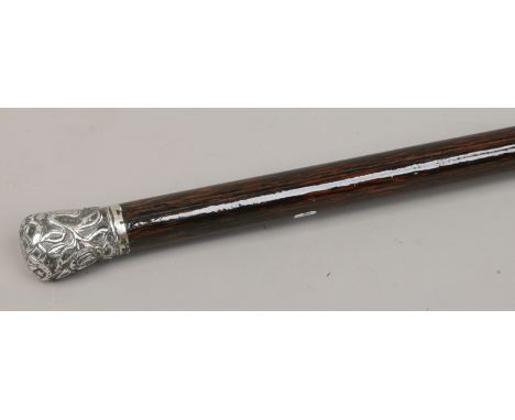 A monogrammed white metal handle walking stick.