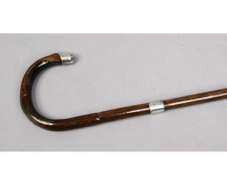 A cane walking stick with silver top and collar assayed Birmingham 1938.