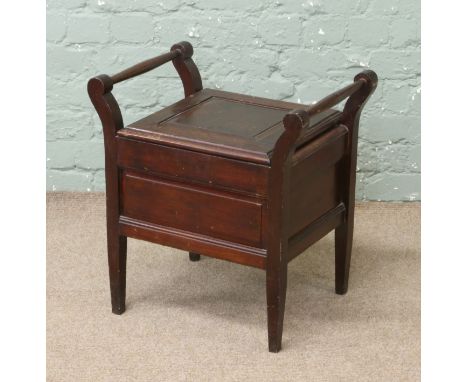 An oak commode on square tapering supports.