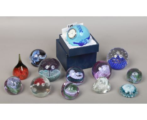 Thirteen Caithness glass paperweights including a boxed example inset with a clock.