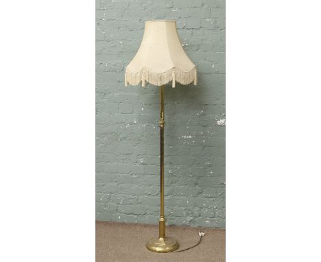 A brass base standard lamp.