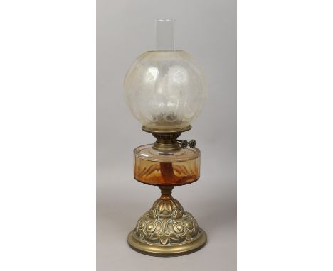 A Victorian brass based oil lamp with frosted glass shade.