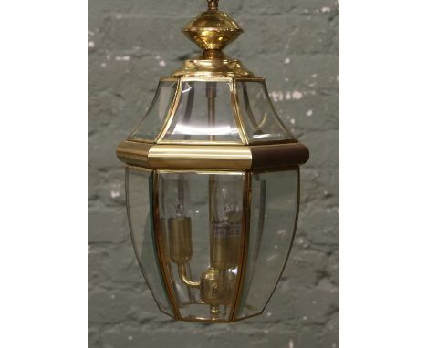 A brass and bevel edge glass three branch hall lantern.