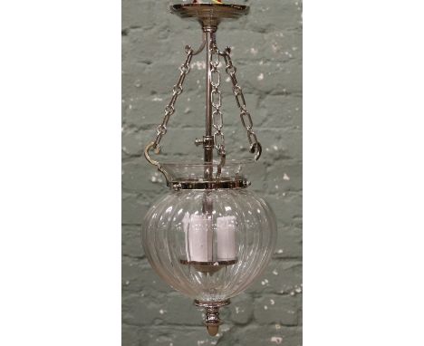 A Chrome three branch hall lantern with ribbed clear glass inverted dome shaped shade.