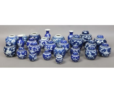 A large collection of C20th Chinese Kangxi style jars and vases decorated in underglaze blue with pruness blossom.