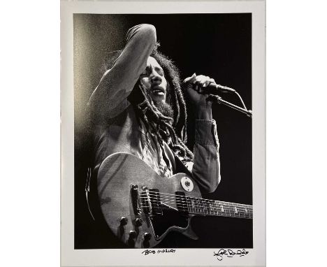 A photographer-signed print of an image depicting Bob Marley by John Rowlands. Measures 22x17".