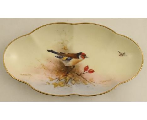 A Royal Worcester shaped oval dish, decorated with a Goldfinch and foliage by E Barker, diameter 11ins