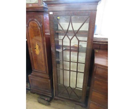 A 19th century narrow bookcase with astragal glazed bars opening to revea l shelves raised on bracket feet W 26 ins x H 66 in