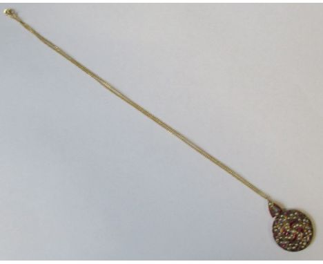 A ruby and pearl set circular pendant, in a yellow metal setting, on a chain, diameter 1.25ins, total weight 7g - some rubies