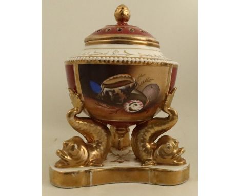 A porcelain covered centre piece, the pierced cover decorated in burgundy and gilt, the body with reserve panel to the front 