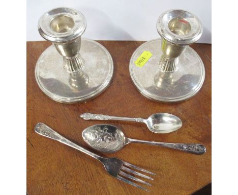 A pair of silver dwarf candlesticks, together with silver Apostle teaspoons and a silver plated Humpty Dumpty christening for