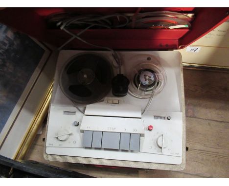 A reel to reel tape recorder and various reels