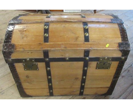 A pine and metal bound dome top trunk, with lift out tray, the interior of the lid with oval label for Madrid
