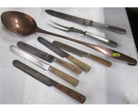 A copper straining spoon, together with a carving knife and fork and five horn handled knives