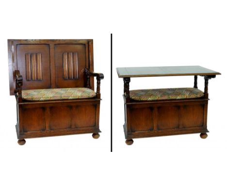 AN OAK MONK'S BENCH WITH LINEN FOLD PANELS TO THE BACK 