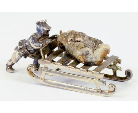 A CONTINENTAL SILVER TOY IN THE FORM OF A MINER PUSHING A SLED LADEN WITH A LUMP OF PYRITE ON QUARTZ, EARLY 20TH CENTURY