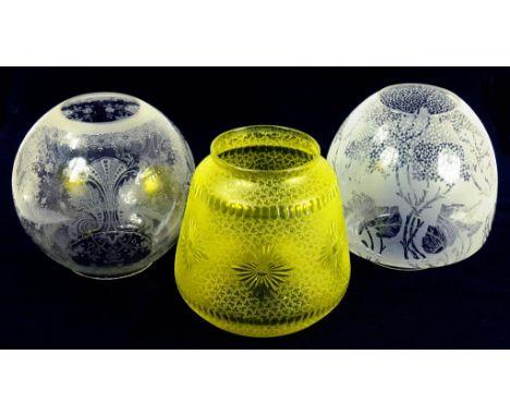 A CHARTREUSE GLASS OIL LAMP SHADE AND TWO ETCHED GLASS GLOBE SHADES 