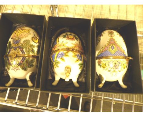 Three boxed ceramic eggs