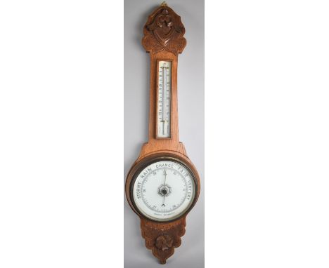 An Edwardian Carved Oak Aneroid Wall Barometer with Thermometer, Onion Topped, 78cm high 