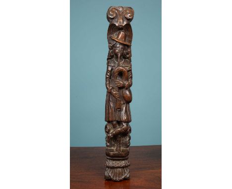 An antique carved oak element depicting a full length figure playing the bagpipesapproximately 11cm wide x 66cm highMinor mar