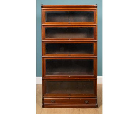 A walnut Globe Wernicke-style graduated five-tier bookcase, with bevelled glass doors and with inset drawer to the plinth bas